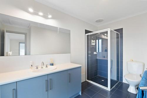 a bathroom with a toilet and a sink and a shower at 27 Seaview - Pets Negotiable - Wi-Fi - No Linen Included in Middleton