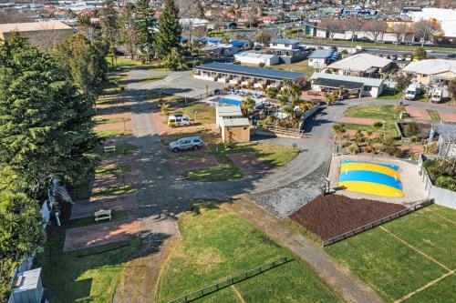 an aerial view of a parking lot with a tent at Tasman Holiday Parks - Rotorua in Rotorua