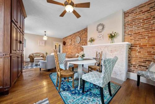 a living room with a table and chairs and a brick wall at The Village Townhouse - 5 BR in Columbus