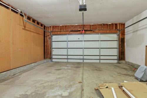 an empty garage with a white garage door at Housepitality - The Gahanna Hideaway in Gahanna