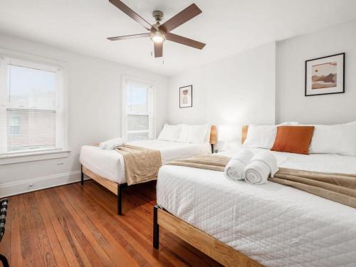 a bedroom with two beds and a ceiling fan at Housepitality - The Cobblestone 2- New Renovation in Columbus