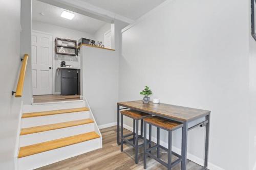a small kitchen with a table and a staircase at Housepitality - The Restful Studio - Cozy in Newark
