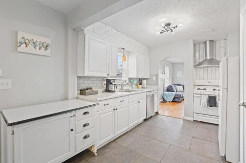 a kitchen with white cabinets and white appliances at Housepitality - Newark Friends and Family House in Newark