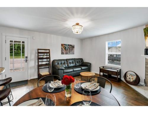 a living room with a couch and a table at Housepitality - Little River Trails in Mason