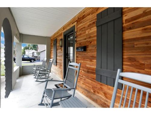 a group of chairs sitting on the porch of a house at Housepitality - Little River Trails in Mason