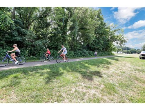a group of people riding bikes down a road at Housepitality - Little River Trails in Mason