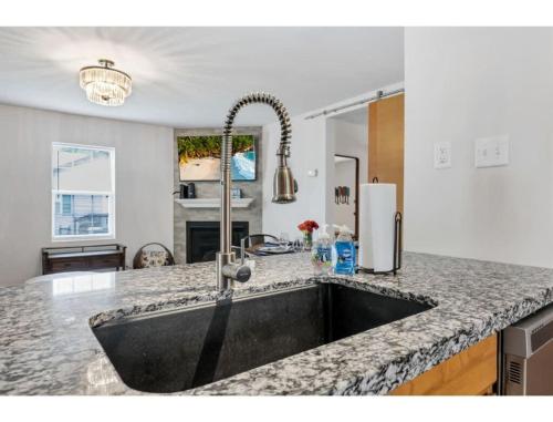 a kitchen with a large sink in a kitchen at Housepitality - Little River Trails in Mason