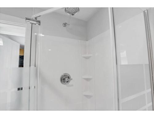 a shower with a glass door in a bathroom at Housepitality - Little River Trails in Mason