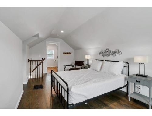a bedroom with a bed and a table and a chair at Housepitality - Little River Trails in Mason