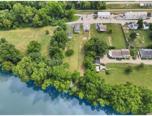 an aerial view of a park with a house and a lake at Housepitality - Little River Trails in Mason