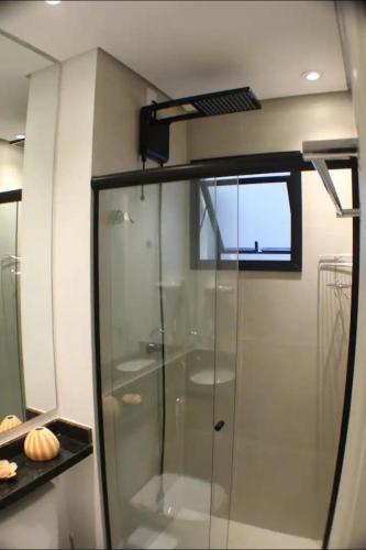 a glass shower in a bathroom with a window at Fabio Av Paulista in São Paulo