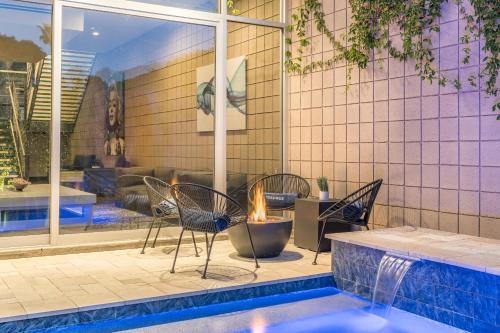 a patio with chairs and a table and a pool at The George - Old Town Scottsdale private micro-resort, near the best restaurants and nightlife in AZ in Scottsdale