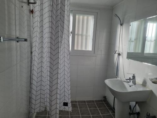 a white bathroom with a sink and a shower at hongdae housing line 2 st 1 min in Seoul
