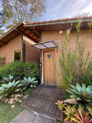 a wooden entrance to a house with a wooden deck at Terra Verde Visconde de Mauá in Visconde De Maua