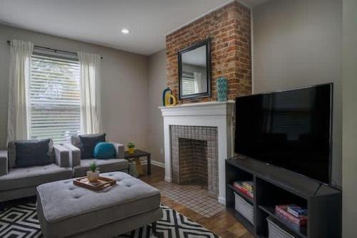 a living room with a fireplace and a flat screen tv at Housepitality - The Lilley Pad - Near Downtown in Columbus
