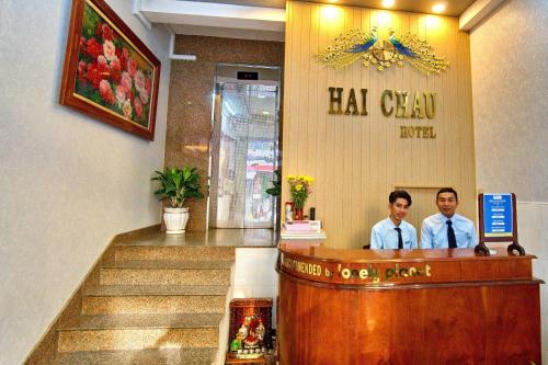 two men sitting at a bar in a salon at Hotel Hải Châu in Ấp Phước Thọ