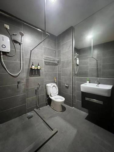 a bathroom with a shower and a toilet and a sink at The Lodge @ Empire Damansara in Petaling Jaya