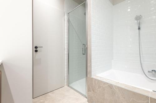 a shower with a glass door in a bathroom at PANORAMIC SUITE - SUPERB flat in the heart of the old town 5 stars in Annecy