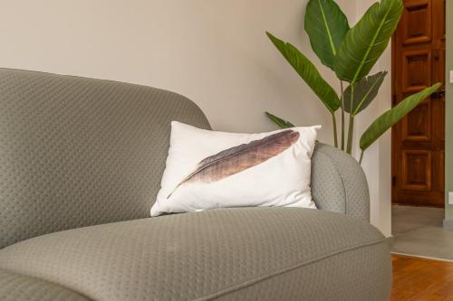 a pillow with a leaf on it next to a chair at PANORAMIC SUITE - SUPERB flat in the heart of the old town 5 stars in Annecy