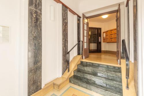 a staircase in a house with a hallway at PANORAMIC SUITE - SUPERB flat in the heart of the old town 5 stars in Annecy