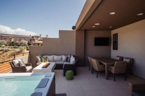 a patio with a pool and a couch and a table at Townhome w Private Hot Tub Air Hockey and more in Washington