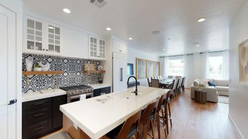 a kitchen with a counter top and a living room at Townhome w Private Hot Tub Air Hockey and more in Washington