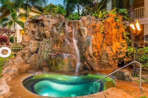 a waterfall in the middle of a pool at C300 Custom 4 bedroom Ocean View Penthouse in Koloa