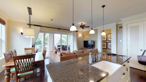 a kitchen and living room with a couch and a table at D210 Second Floor 3-bedroom Poolside Lanai in Koloa