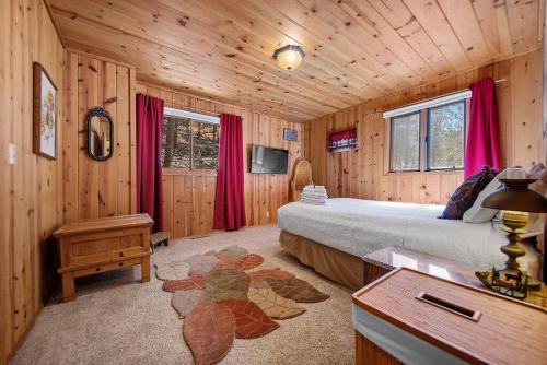 a bedroom with a bed and a desk in a cabin at Holiday House in Rapid City