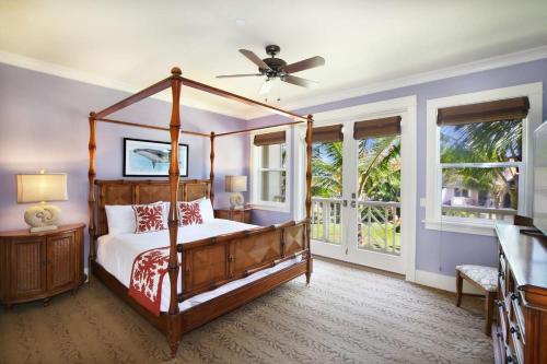 a bedroom with a bed and a ceiling fan at D211 Second Floor 3-bedroom Poolside Lanai in Koloa
