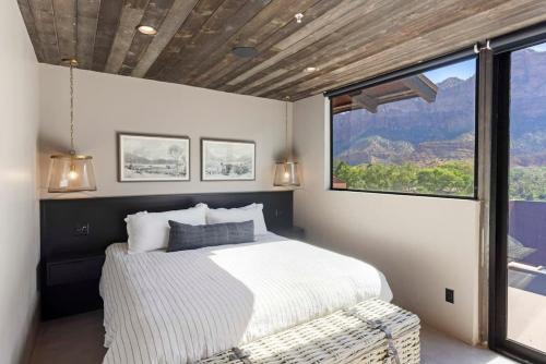 a bedroom with a bed and a large window at Zion loft with canyon views - unit 2 in Springdale