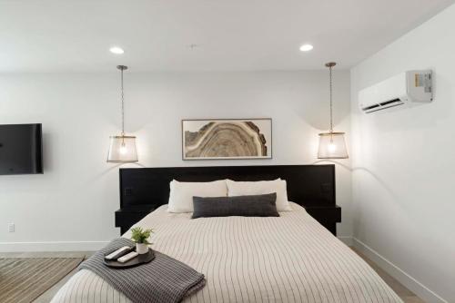 a bedroom with a large bed and two pendant lights at Zion loft basement unit 4 in Springdale