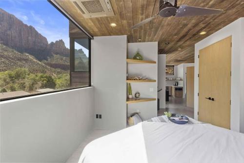 a bedroom with a bed and a large window at The Loft at Zion in Springdale