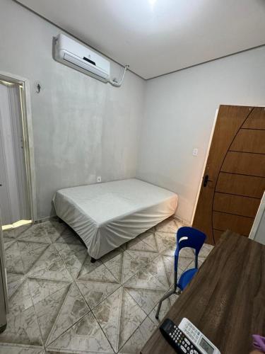 a room with a bed and a desk and a chair at Condomínio Alencar in Parauapebas