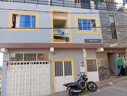 a motorcycle parked in front of a house at Hotel Oiba Alfa Plaza in Oiba