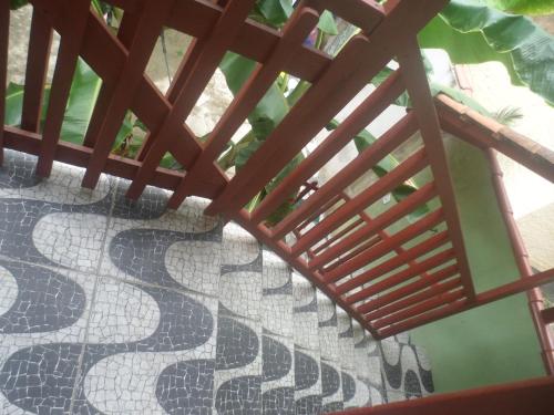 a tiled floor with a wooden railing on a balcony at Casa da Dona Dita in Paraty