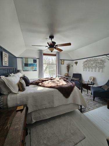 a bedroom with a large bed and a ceiling fan at The Walnut Grove BnB in Harrow