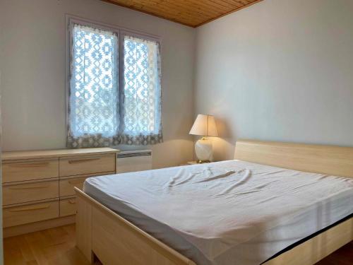 une chambre avec un grand lit et une fenêtre dans l'établissement Maison Lumineuse avec Piscine Privée près de la Plage - Longeville-sur-Mer - FR-1-336-151, à Longeville-sur-Mer