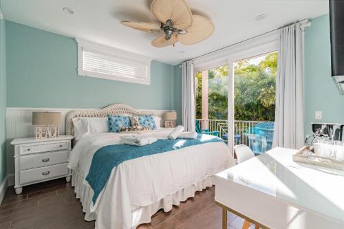 a bedroom with a bed with a ceiling fan at Playa Esmeralda Home! Bradenton Beach Now Open!!! in Bradenton Beach