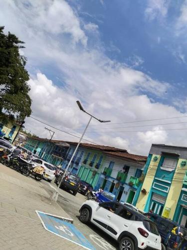 a white car parked on a street next to buildings at Encantadora Casa, Calima Darién in Darién