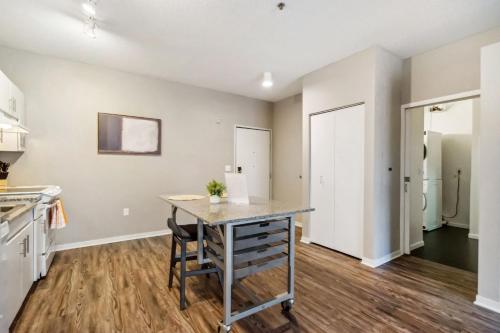 an empty kitchen with a table and chairs at CozySuites Mill District with pool, gym #02 in Minneapolis