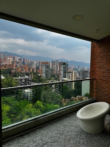 a large window with a view of a city at Blux 1305 Poblado Medellín Colombia in Medellín