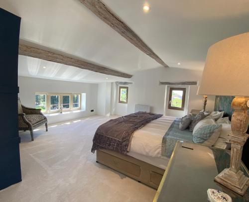 a large bedroom with a large bed and a desk at Bastide de Peyloubet in Grasse