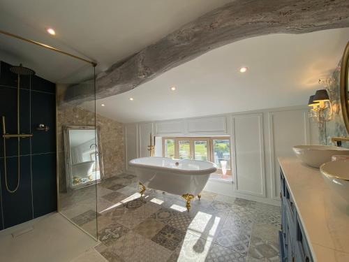 a bathroom with a tub and a glass shower at Bastide de Peyloubet in Grasse