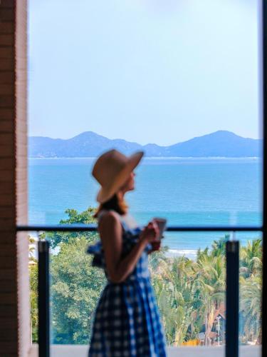 a woman wearing a hat looking at her cell phone at DoubleTree by Hilton Shanwei in Shanwei