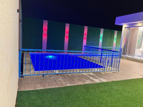 a blue cage with a swimming pool in a building at شاليه جود in Riyadh