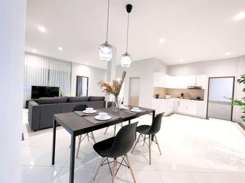 a kitchen and living room with a table and chairs at Prime Hill , Kathu Phuket / F3 in Phuket Town