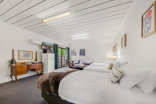 a bedroom with a large white bed and a desk at Bright Velo in Bright