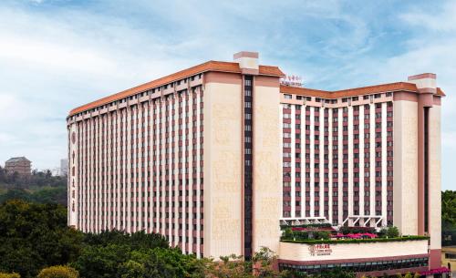 a large building with a lot of windows at China Hotel Guangzhou - Subway direct to Pazhou Exhibition Center, Free shuttle during Canton Fair & Exhibitor registration Counter in Guangzhou