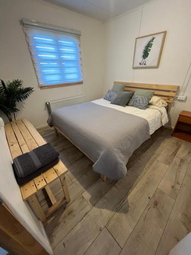 a bedroom with a large bed and a window at Cabañas Little Home in Puerto Natales